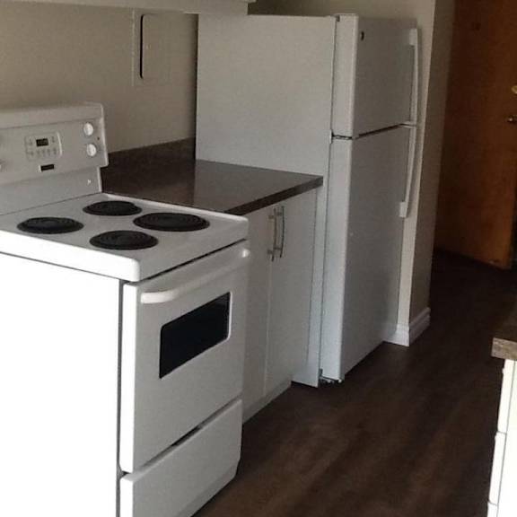 a white stove and refrigerator in a kitchen.