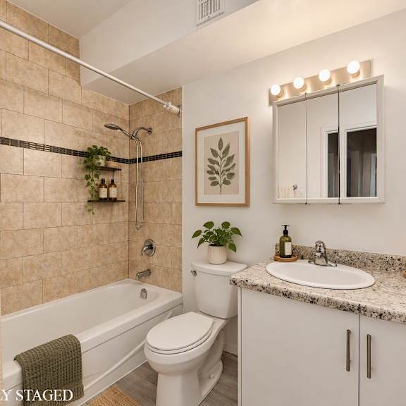 bathroom with a white toilet, a bathtub with a shower curtain, a sink, and a mirror.
