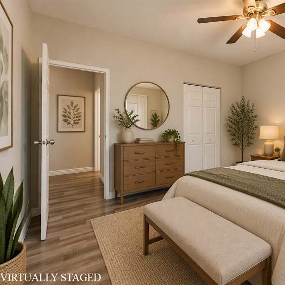 a bedroom with a bed, dresser, and mirror.