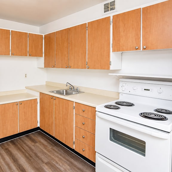 a kitchen with wooden cabinets and white appliances.