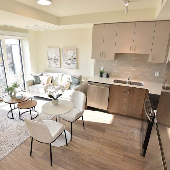 a kitchen with a white couch and a table with chairs at roxy apartments, hamilton, ontario