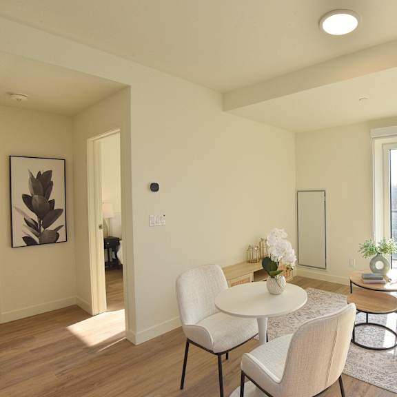 a modern living room with a white table and chairs at roxy apartments, ontario