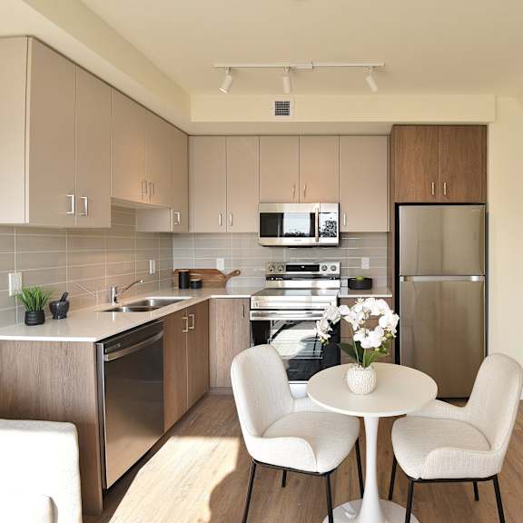 a kitchen with a table and chairs at roxy apartments, ontario, l8h 0b7