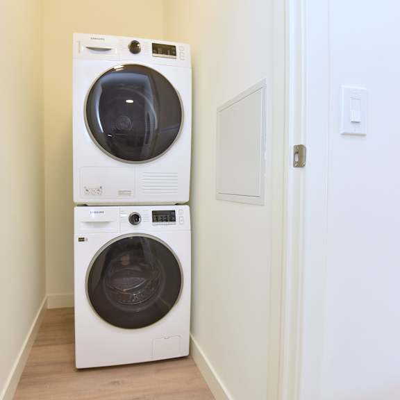 a white front loading washing machine at roxy apartments, hamilton, on