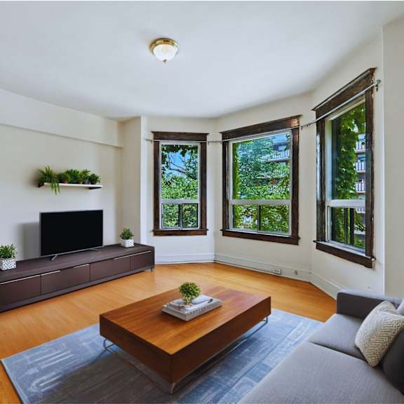 a living room with a grey couch and a wooden coffee table.