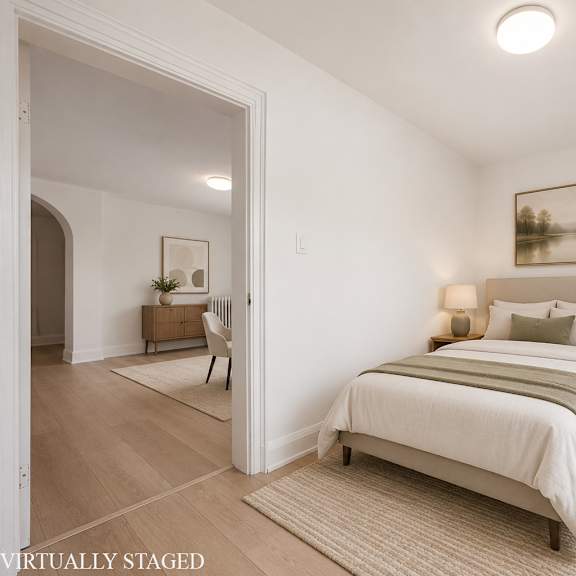 a bedroom with a large bed and a painting on the wall.