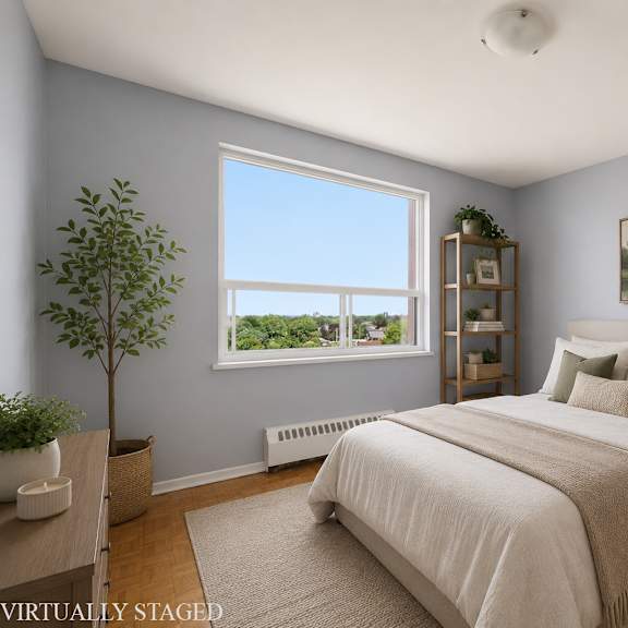 a bedroom with a large bed and a window overlooking a lake.