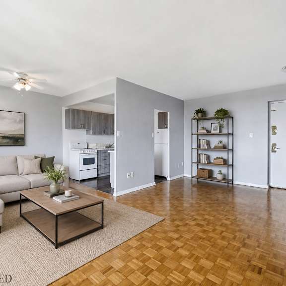 a living room with a couch, coffee table, and a painting on the wall.