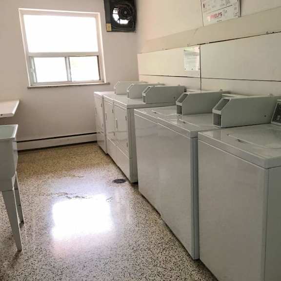 a room with a row of washing machines.