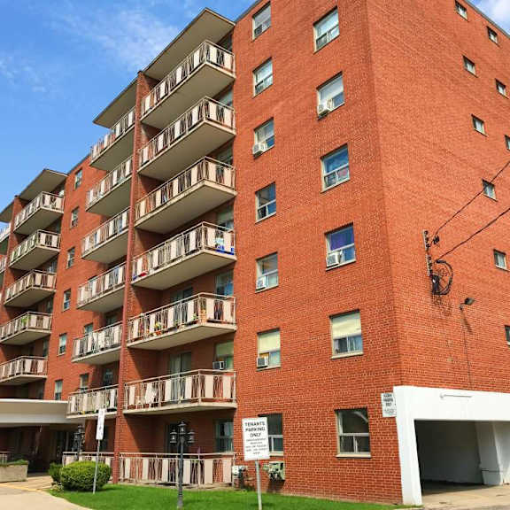 a red brick apartment building with a white garage door.