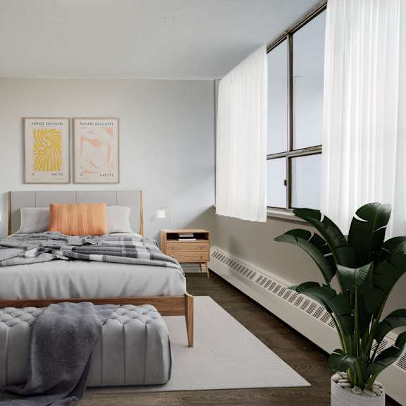 a bedroom with a large bed and a plant.