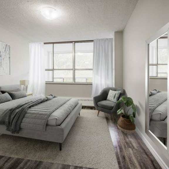 a bedroom with a large bed and a chair.