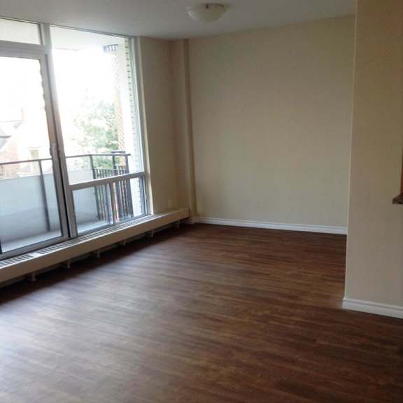 a room with wooden floors and a window.