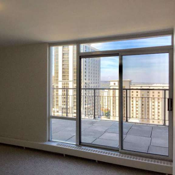a room with a large window overlooking a cityscape.