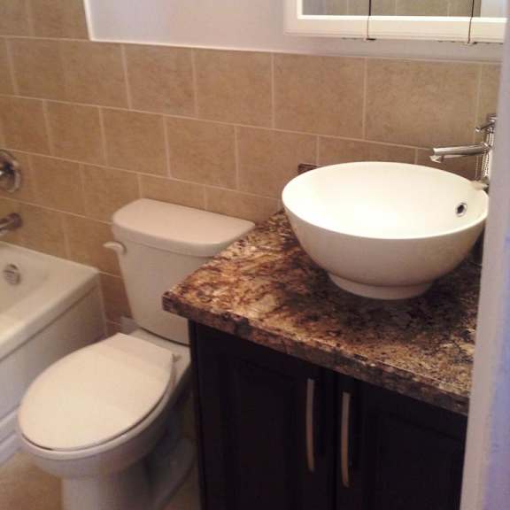 a white toilet sits next to a sink in a bathroom.