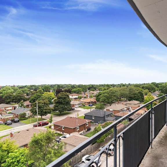 a balcony overlooks a residential neighborhood.