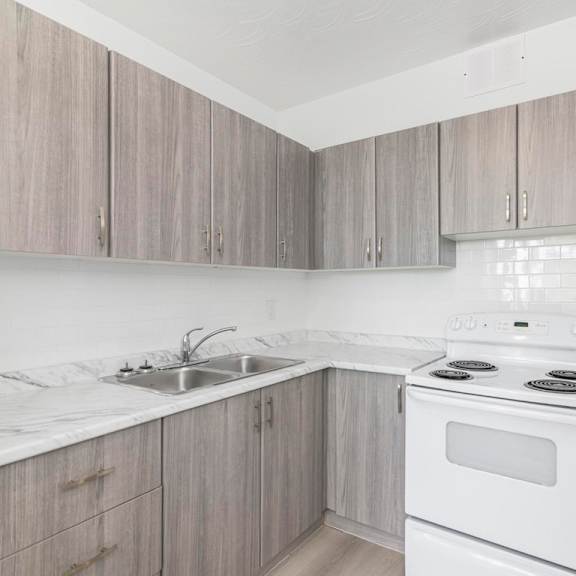 a kitchen with a white stove and sink.