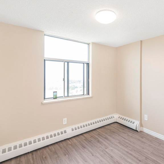 a room with a window and a radiator on the floor.