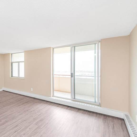 a room with a sliding glass door and a window.