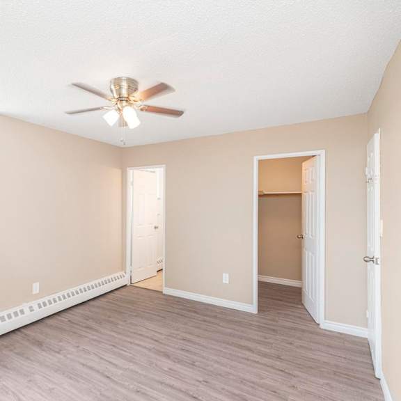 a room with a ceiling fan and a window.