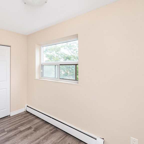 a room with a white door and a window with a white frame.