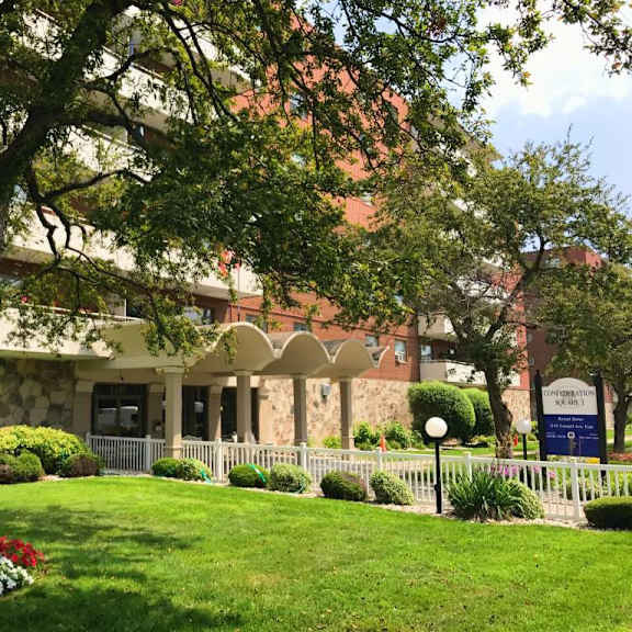 a building with a white fence and a sign that says "campus".