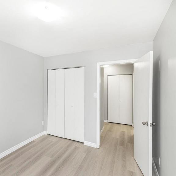 a white room with a door and a window.