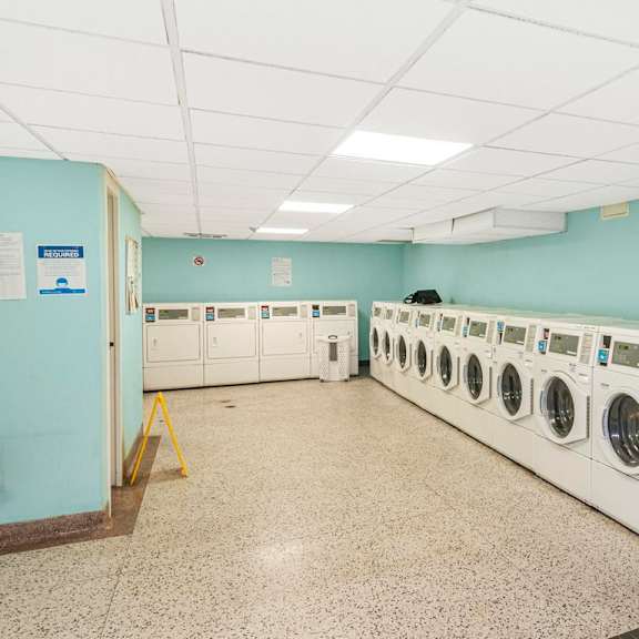 a row of washing machines in a laundromat.