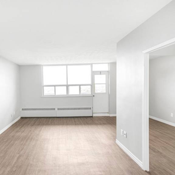 a room with a window and a radiator on the wall.