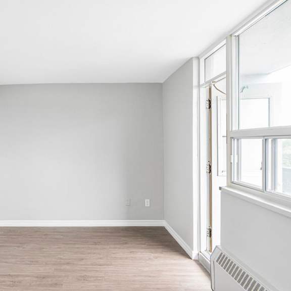 a room with a window and a radiator on the wall.