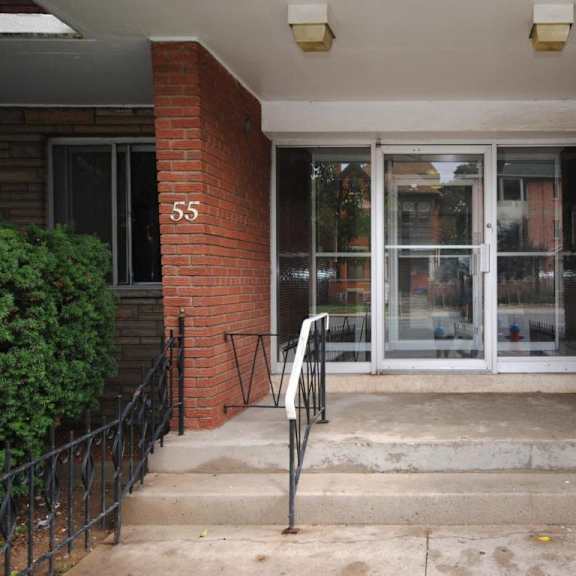 the front door of a building with the number 55 on it.