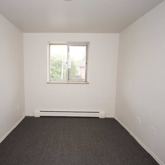 a room with a window and a radiator on the floor.