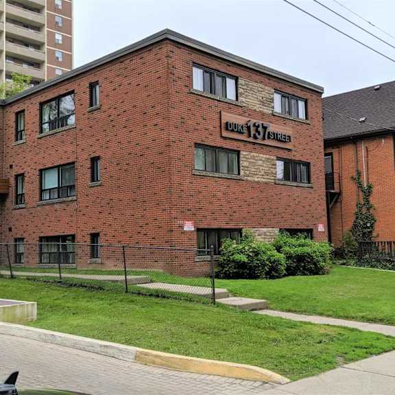 a red brick building with the words "hillcrest manor" on the front.