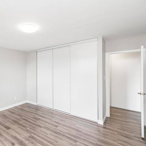a room with white walls and a wooden floor.