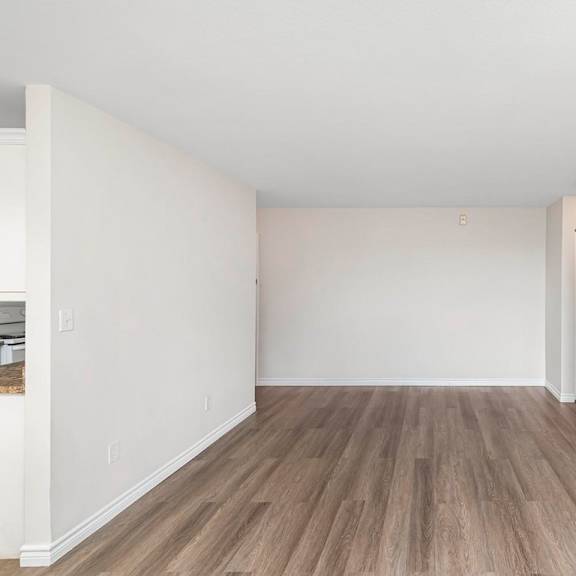 a room with wooden flooring and white walls.