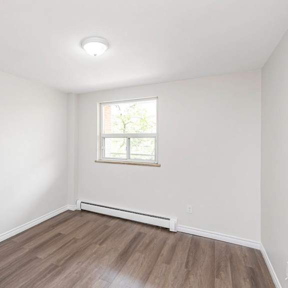a room with a window and a white ceiling.