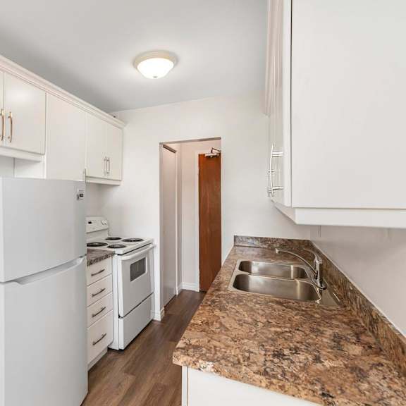 a kitchen with white appliances and cabinets.