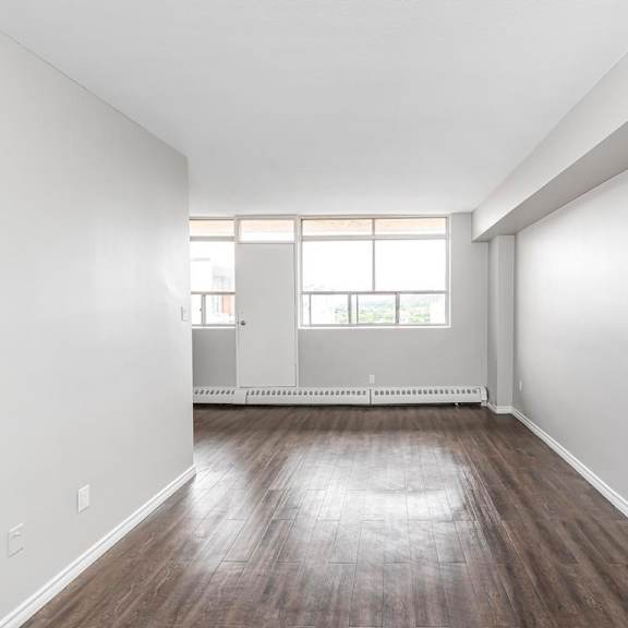 a room with wooden floors and white walls.