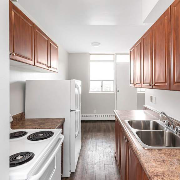 a kitchen with a white stove top oven and a white refrigerator.