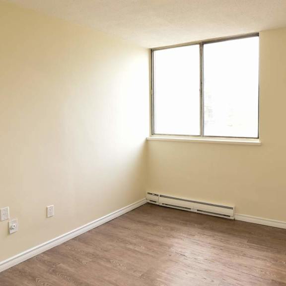 a room with a window and a radiator on the wall.