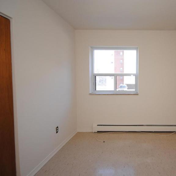 a room with a window and a radiator on the floor.