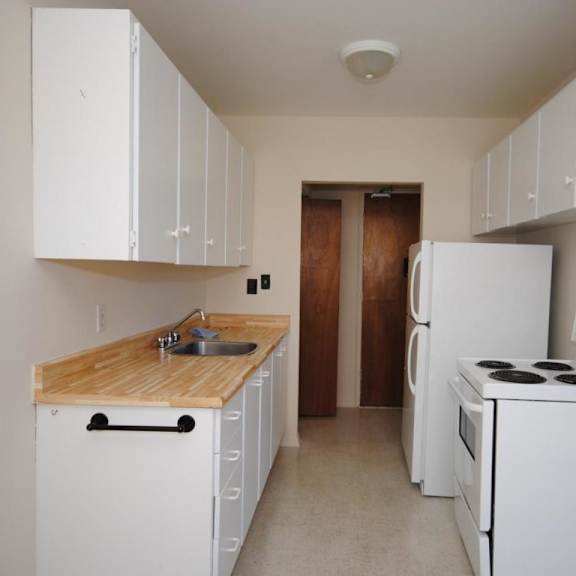 a kitchen with white appliances and cabinets.