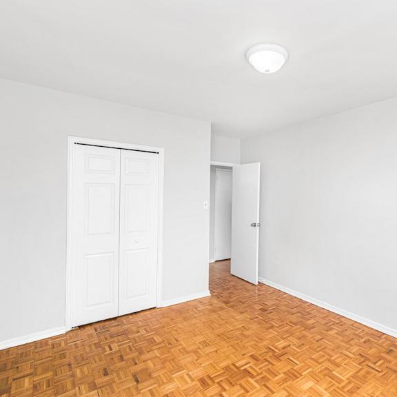 a room with a wooden floor and white walls.
