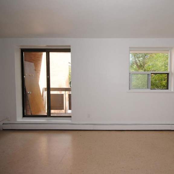 a room with a window and a door leading outside.