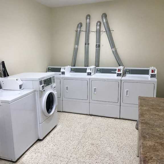 a laundry room with washers and dryers.