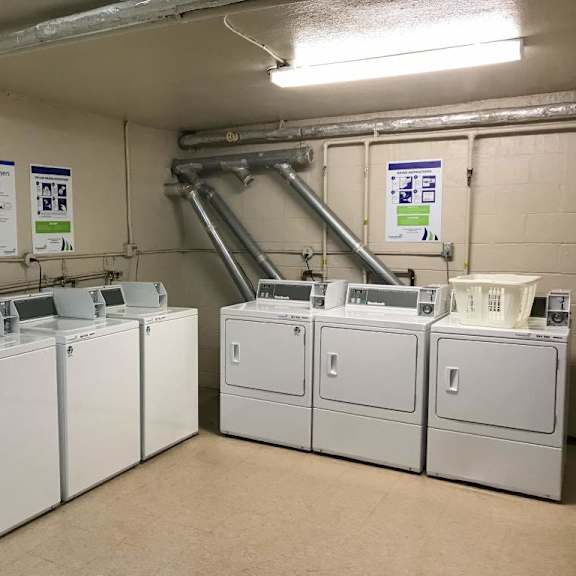 a laundry room with washers and dryers.