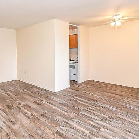 a room with wooden flooring and a ceiling fan.