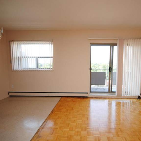 a room with a wooden floor and a sliding glass door.