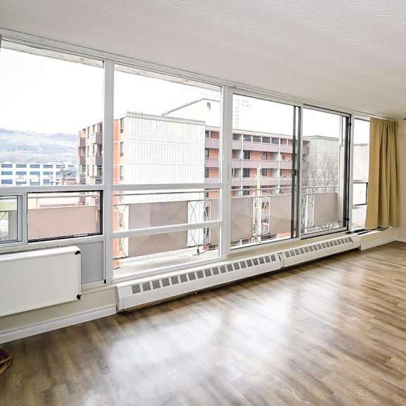 a room with a large window overlooking a cityscape.
