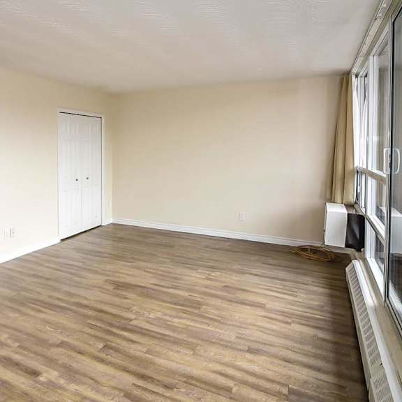 a room with wooden flooring and white walls.